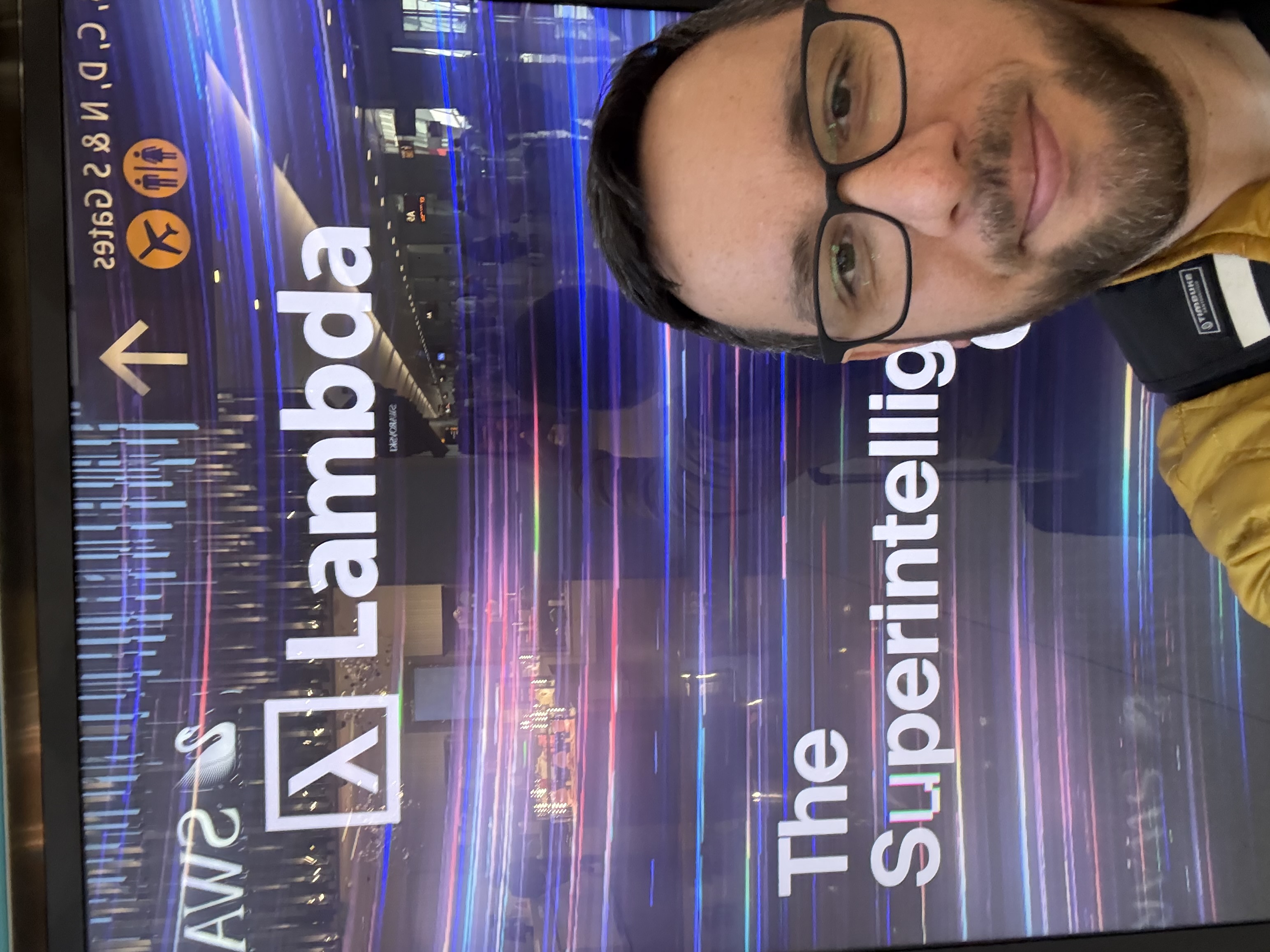 Me at the SEA Airport, with a Lambda advertisement